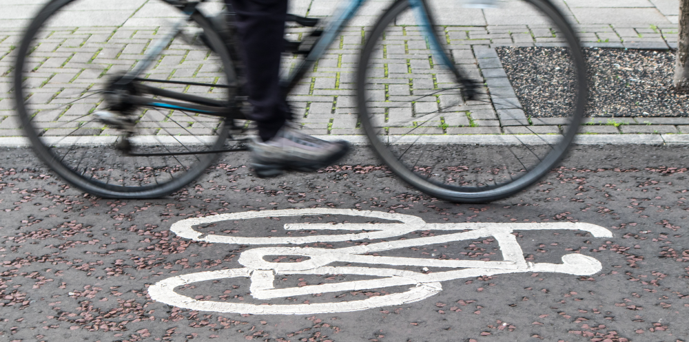 This image: an illustrative photo of a cyclist in a cycle lane. The map: a map of the illustrative masterplan, overlaid with existing and proposed new footpaths and bridleways in and around the site. There are green map markers which display more detail about the key proposals for the public rights of way around the site. Local cycle connections to and from Hinckley, Leicester and Nuneaton can also be seen by zooming the map out.